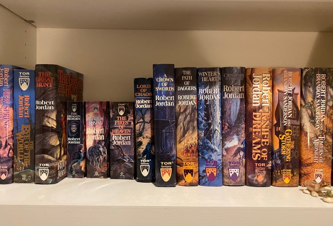 Photograph of books 1-13 of Robert Jordna's Wheel of Time series plus its prequel, New Spring